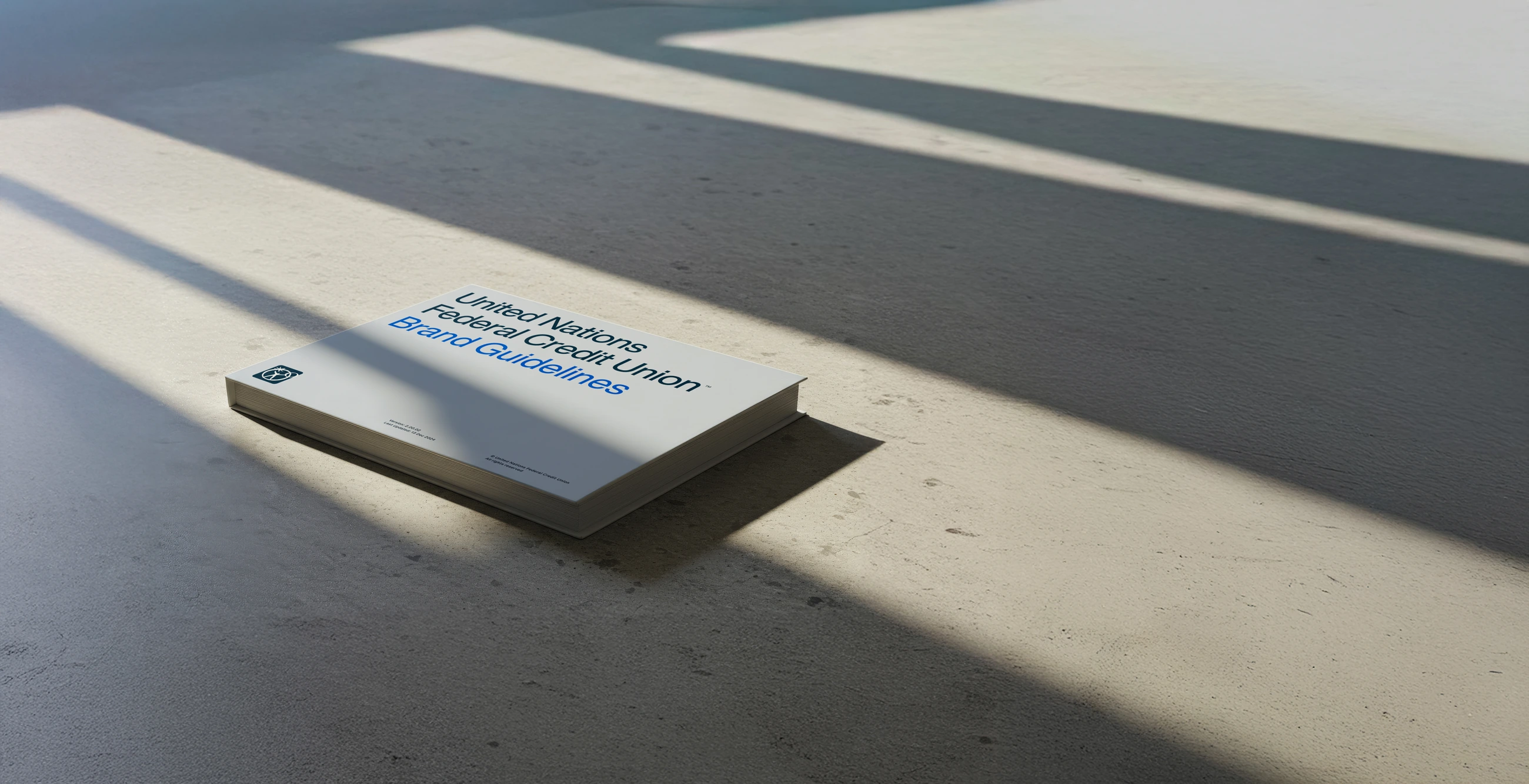 UNFCU brand guidelines, designed as a carefully typeset book in directional daylight